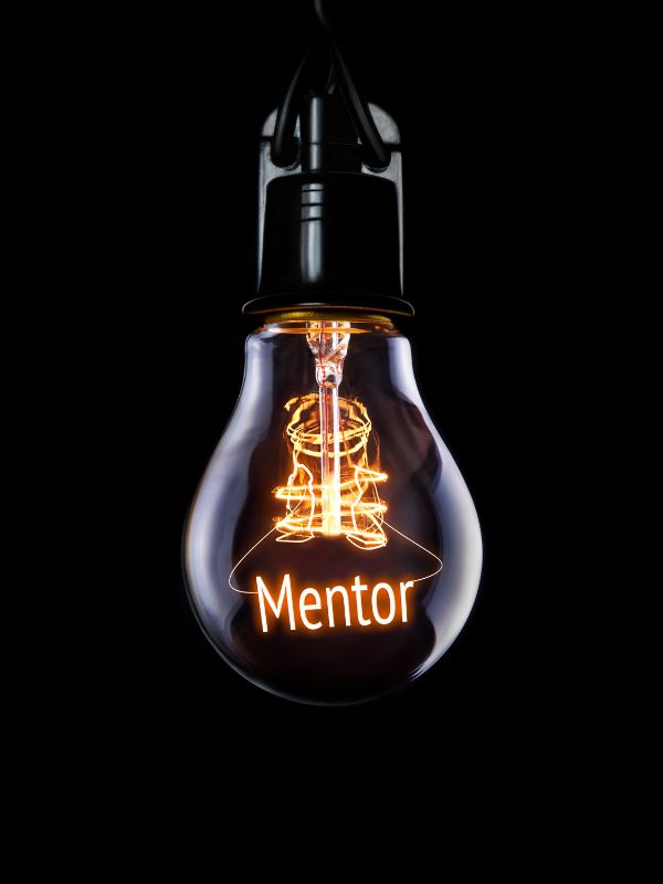 a lit bulb with the word 'mentor' written in it